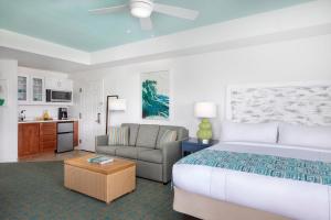 a bedroom with a bed and a couch and a chair at Marriott's Harbour Lake in Orlando