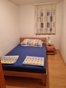 a bedroom with a bed and two pillows on it at Apartment Kati in Novigrad Istria