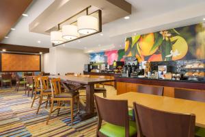 a restaurant with tables and chairs and a bar at Fairfield by Marriott Inn & Suites Houston North/Cypress Station in Houston