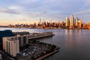 a view of a city with a river and buildings at Sheraton Lincoln Harbor Hotel in Weehawken