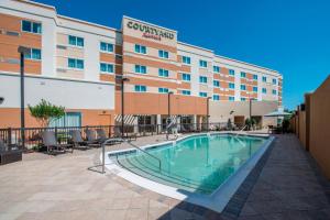 a hotel with a swimming pool in front of a building at Courtyard by Marriott Columbus in Columbus