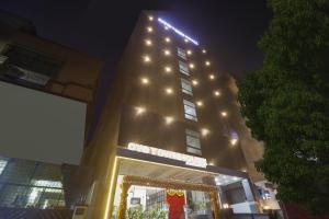 a building with lights on top of it at night at Townhouse Ameerpet in Ameerpet