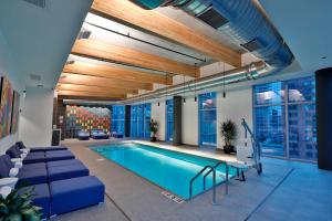 a swimming pool in a room with a building at Aloft Chicago Mag Mile in Chicago