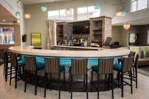 a bar in a hotel lobby with chairs around it at Residence Inn by Marriott Cleveland Avon at The Emerald Event Center in Avon