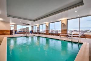 a large swimming pool in a building with windows at Fairfield by Marriott Inn & Suites Laurel in Laurel