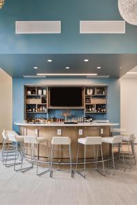 a bar with stools and a tv in a room at Element Chattanooga East Marriott in Chattanooga