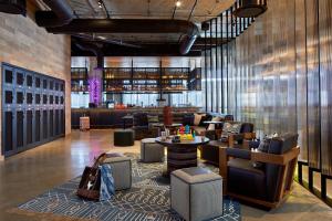 a lobby with couches and tables and a bar at Moxy Columbus Short North in Columbus