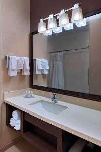a bathroom with a sink and a large mirror at Fairfield Inn and Suites by Marriott Austin Northwest/Research Blvd in Austin