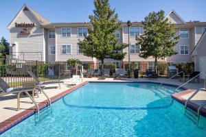 a swimming pool in front of a building at Residence Inn Houston Sugar Land/Stafford in Stafford