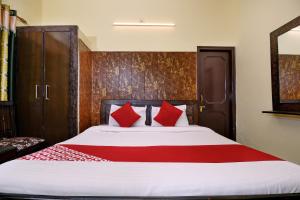 a bedroom with a large bed with red pillows at Morning Star in Mājra