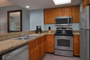 a kitchen with a sink stove and a microwave at Marriott's Harbour Point and Sunset Pointe at Shelter Cove in Hilton Head Island