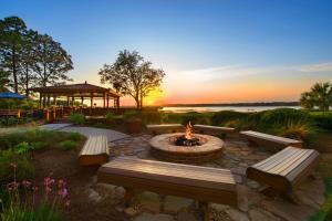 a fire pit with benches and a gazebo with the sunset at Marriott's Harbour Point and Sunset Pointe at Shelter Cove in Hilton Head Island