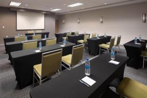 a conference room with tables and chairs with water bottles on them at Four Points by Sheraton Chicago Schaumburg in Schaumburg