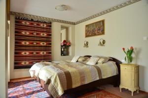 a bedroom with a bed and a dresser at Pensjonat B&B Nad Rudawą in Krakow