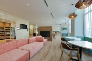 a living room with a pink couch and a table at Residence Inn by Marriott Cancun Hotel Zone in Cancún