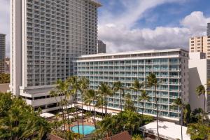 a large building with palm trees in front of it at Sheraton Princess Kaiulani in Honolulu
