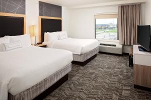 a hotel room with two beds and a flat screen tv at SpringHill Suites by Marriott Green Bay in Green Bay +15 photos