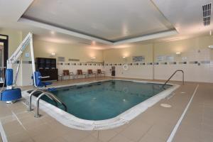 a large swimming pool in a building at Courtyard Charlotte Concord in Concord