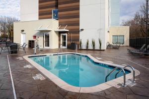 a swimming pool in front of a building at TownePlace Suites by Marriott Gainesville in Gainesville