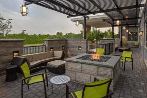 une terrasse avec un canapé et un foyer extérieur. dans l'établissement SpringHill Suites by Marriott East Rutherford Meadowlands Carlstadt, à Carlstadt