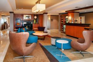 a lobby with chairs and tables and a fireplace at Fairfield Inn and Suites by Marriott Colorado Springs North Air Force Academy in Colorado Springs