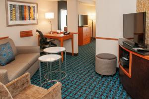 ein Hotelzimmer mit einem Sofa und einem Tisch in der Unterkunft Fairfield Inn and Suites by Marriott Colorado Springs North Air Force Academy in Colorado Springs
