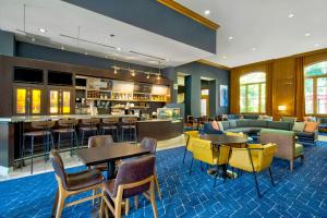 a hotel lobby with tables and a bar at Courtyard by Marriott Nashville Green Hills in Nashville