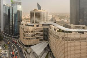 a large building in the middle of a city at Marriott Executive Apartments Kuwait City in Kuwait