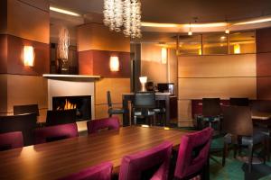 a dining room with a table and chairs and a fireplace at SpringHill Suites Dallas DFW Airport North/Grapevine in Grapevine
