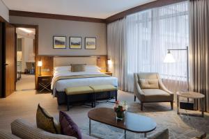 a hotel room with a bed and a living room at Marriott Executive Apartments Kuwait City in Kuwait +35 photos