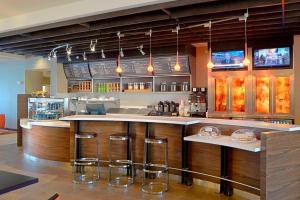 a kitchen with a counter with bar stools at Courtyard by Marriott Muncie at Horizon Convention Center in Muncie