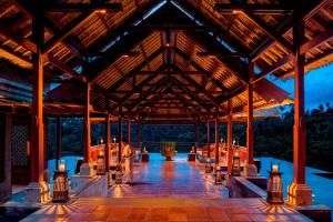 a large pavilion with tables and candles in it at Mandapa, a Ritz-Carlton Reserve in Ubud