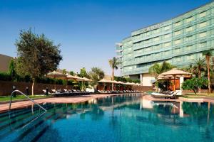 a large swimming pool in front of a hotel at Le Meridien Cairo Airport in Cairo