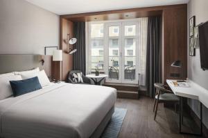 a hotel room with a large bed and a window at Prague Marriott Hotel in Prague