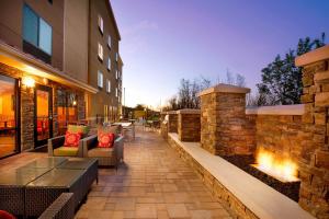 a patio with furniture and a brick wall at TownePlace Suites Bridgeport Clarksburg in Bridgeport