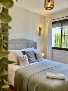 a bedroom with a large bed with a large window at Hacienda el Tarajal in Priego de Córdoba