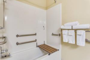 a bathroom with a shower and white towels at TownePlace Suites by Marriott Dallas Bedford in Bedford +18 photos