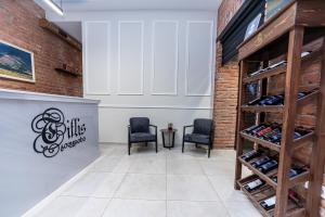 a tasting room with two chairs and a wine rack at Tiflis Hotel in Tbilisi City