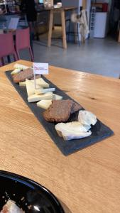 duas fatias de pão e queijo numa mesa em Val D’Illiez mountain apartment. em Val dʼIlliez