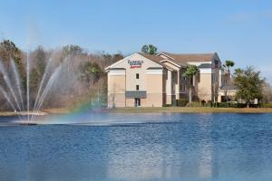 a building with a fountain in the middle of a lake at Fairfield Inn and Suites by Marriott Saint Augustine I-95 in St. Augustine