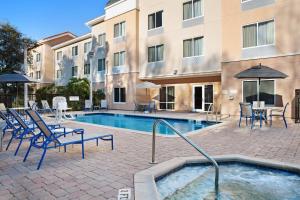 a pool with chairs and tables and a building at Fairfield Inn and Suites by Marriott Saint Augustine I-95 in Saint Augustine