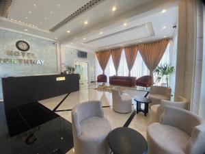 a living room with a grand piano and chairs at Hotel NorthWay in Vavuniya