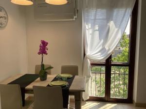 a dining room with a table and a window at Diego's Apartment - Monza Park in Biassono