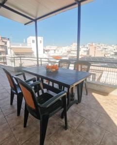 a table and chairs on top of a roof at Summer blossom apartment in Chalkida