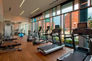a gym with a lot of treadmills and elliptical machines at SpringHill Suites by Marriott Denver Downtown in Denver