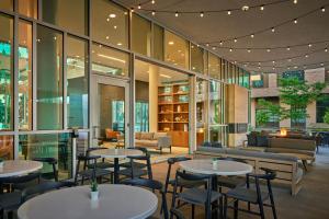 a restaurant with tables and chairs in a building at SpringHill Suites by Marriott Denver Downtown in Denver