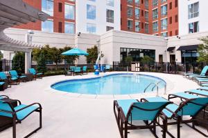 a large swimming pool with chairs and a table at Residence Inn by Marriott Little Rock Downtown in Little Rock