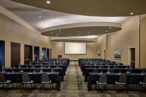 a conference room with tables and chairs and a screen at SpringHill Suites by Marriott Denver Downtown in Denver