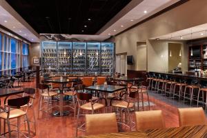a restaurant with tables and chairs and a bar at The Westin Lake Mary, Orlando North in Lake Mary