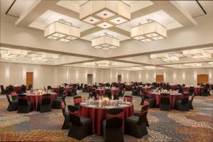 a banquet hall with tables and chairs and chandeliers at The Westin Lake Mary, Orlando North in Lake Mary